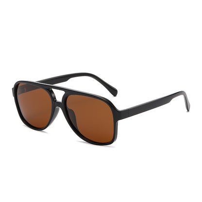 Black sunglasses with brown lenses on a white background