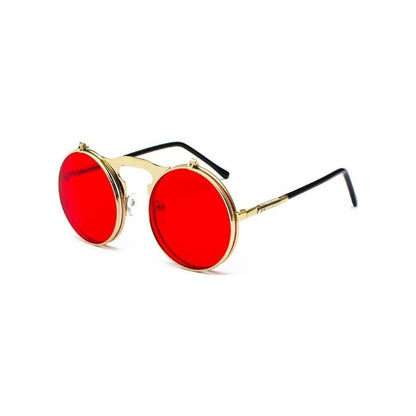Sunglasses with red lenses and gold frames on a white background
