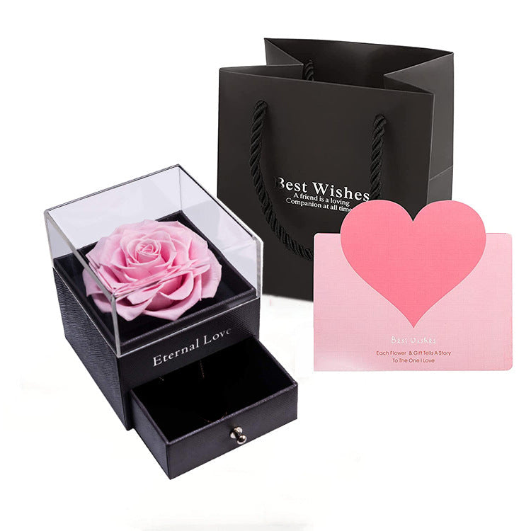 Acrylic jewelry gift box with pink preserved rose in a clear top display