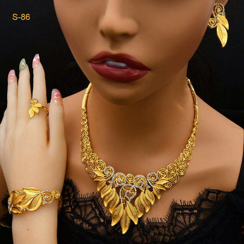 Gold-plated bridal jewelry set with ornate necklace, leaf earrings, ring, and bracelet