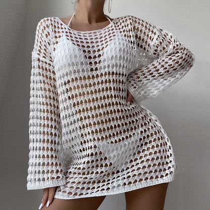 White crochet dress with long sleeves on a plain background