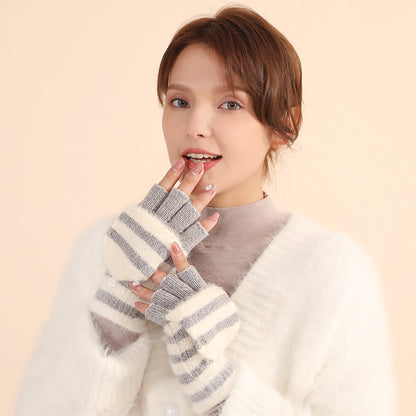Woman wearing striped fingerless gloves against a beige background
