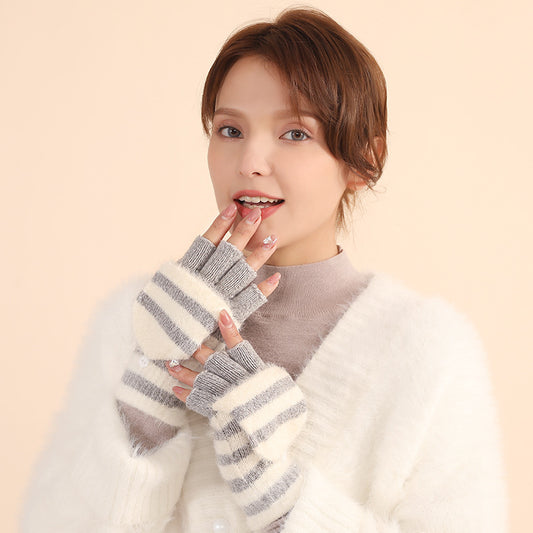 Woman wearing striped fingerless gloves against a beige background