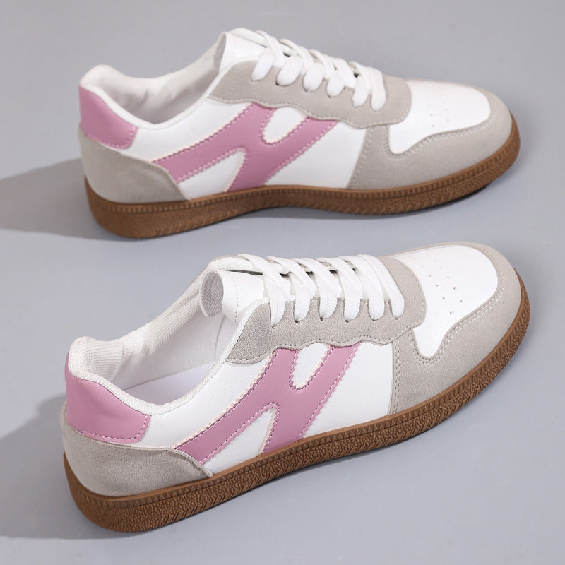 Women's low-top color-block sneakers, white with pink panels, lace-up design.