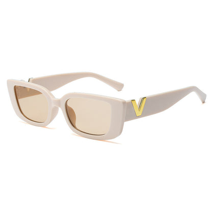 Beige sunglasses with a gold 'V' on a white background