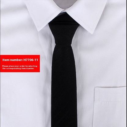 Black tie worn with a white shirt on a light gray background