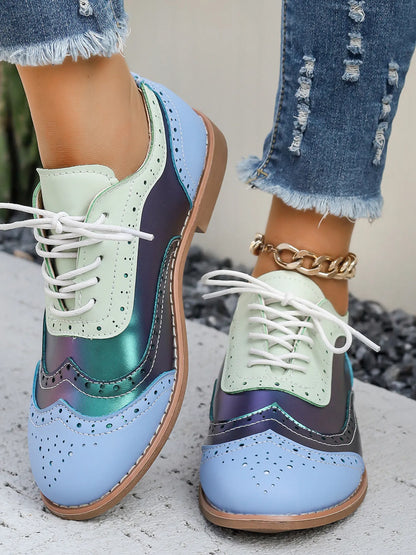 Pastel blue and mint color-block lace-up flats with round toe and white laces