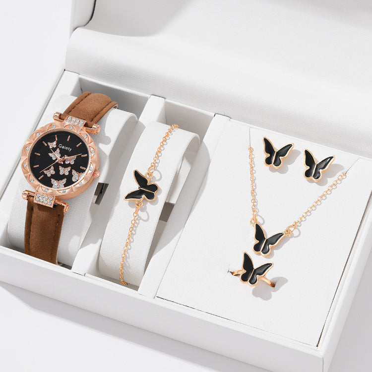 Jewelry set with a watch, bracelet, and necklace featuring butterfly designs in a white box.