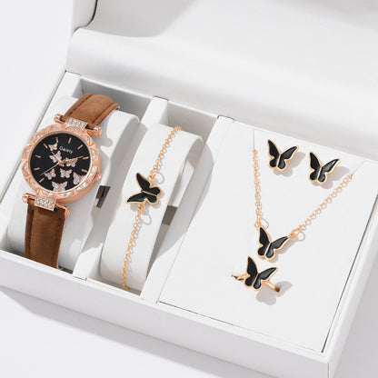 Jewelry set with a watch, bracelet, and necklace featuring butterfly designs in a white box.