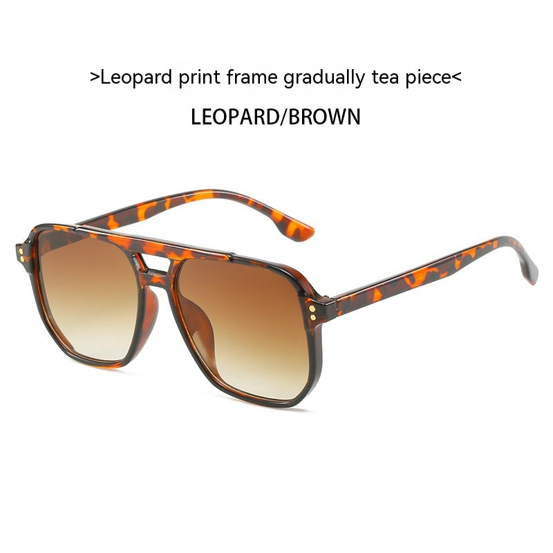 Sunglasses with leopard print frame and brown gradient lenses on a white background