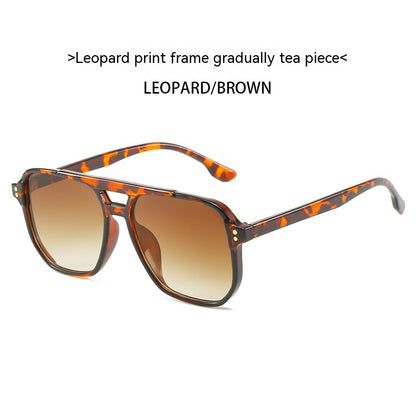 Sunglasses with leopard print frame and brown gradient lenses on a white background