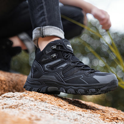 Black hiking boot on a rocky surface with a blurred natural background