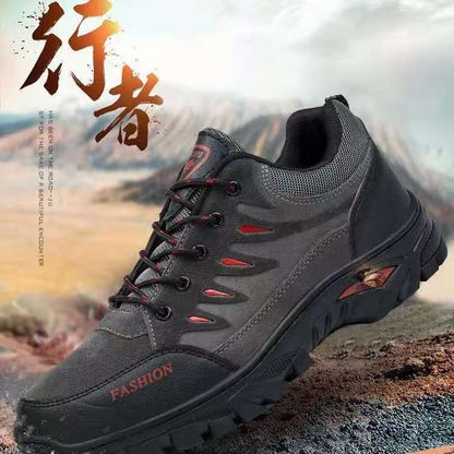 Black hiking shoe with red accents on a mountainous background