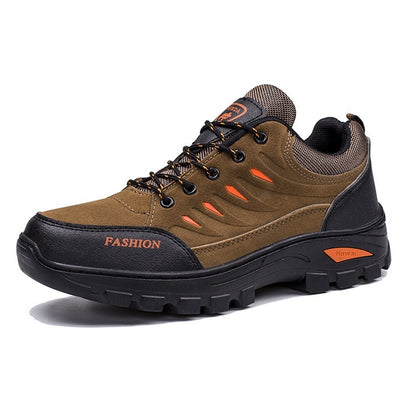 Brown and black hiking shoe with orange accents on a white background