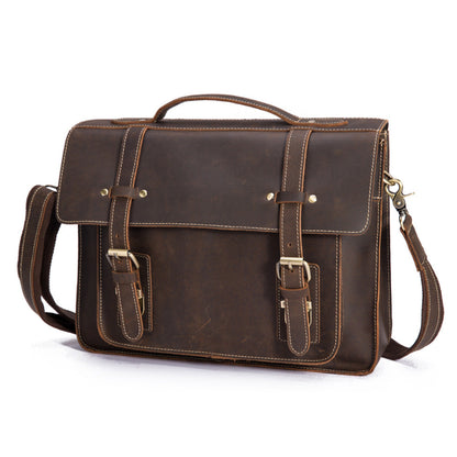 Brown leather briefcase with gold buckles on a white background