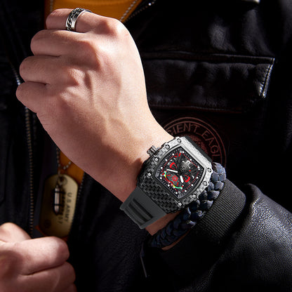 Close-up of a person wearing a luxurious watch with a black strap and intricate design.