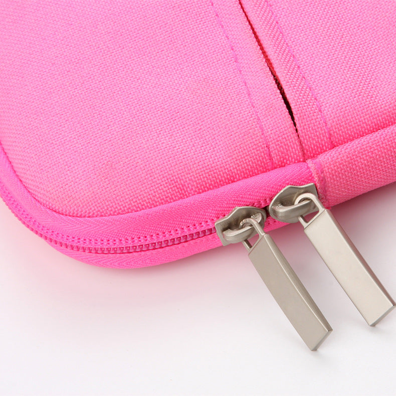 Close-up of a pink zippered pouch with metal zipper pull on a light pink background