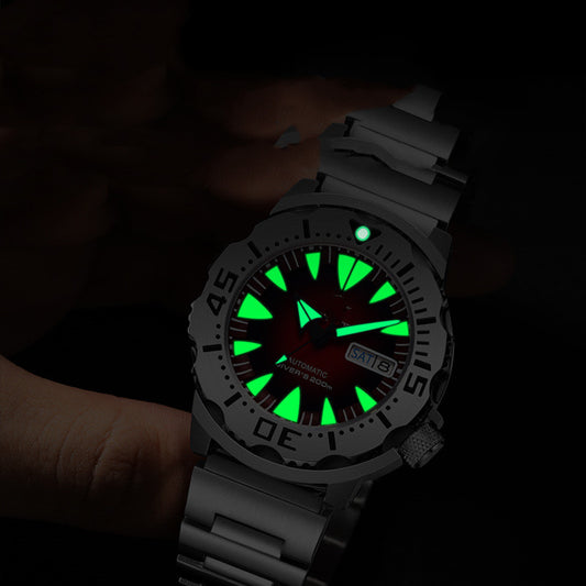 Diving Watch with a glowing Luminous face held in a hand against a dark background