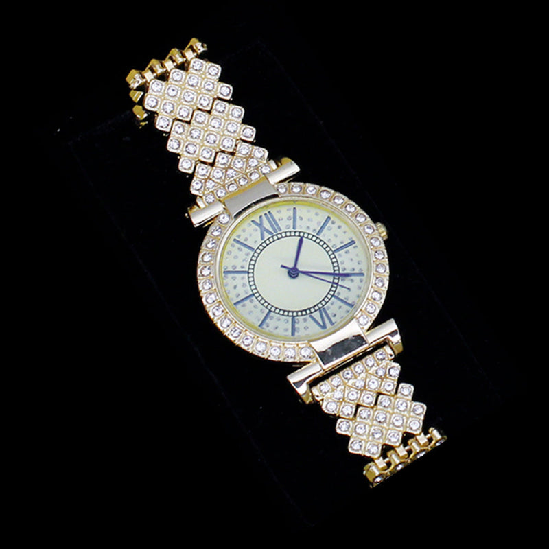 Gold watch with diamond-studded band on a black background