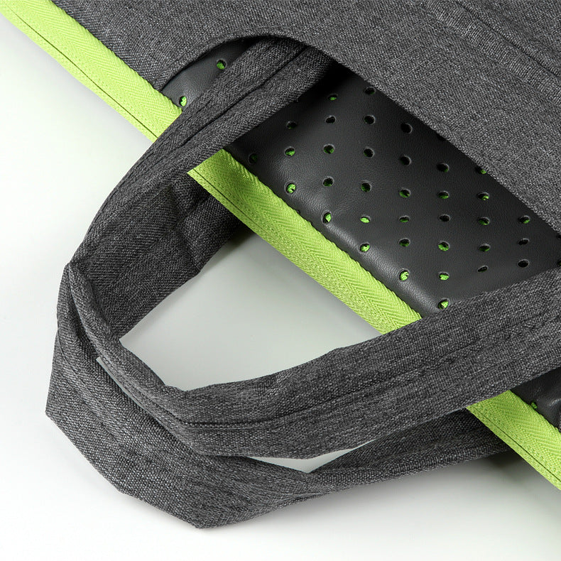 Gray backpack with green interior padding on a white background