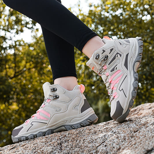 White and pink hiking sneakers with rugged tread and lace-up closure