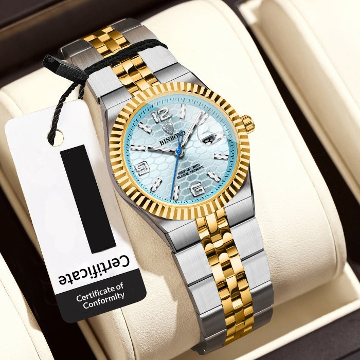 Luxury women's watch with gold and silver straps on a white cushion, featuring a visible brand tag.