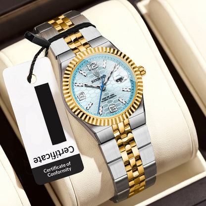 Luxury women's watch with gold and silver straps on a white cushion, featuring a visible brand tag.