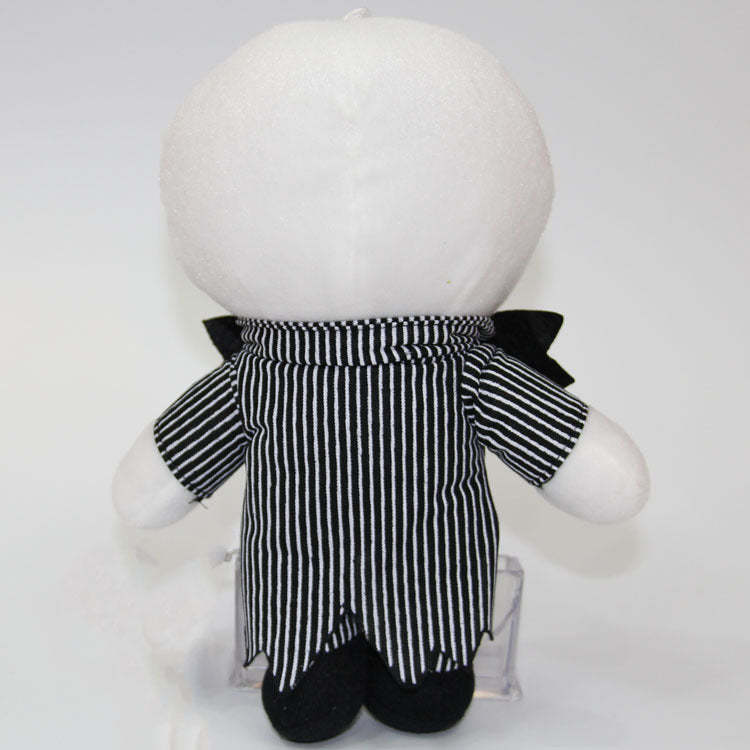 White plush toy with a black and white striped outfit on a light gray background