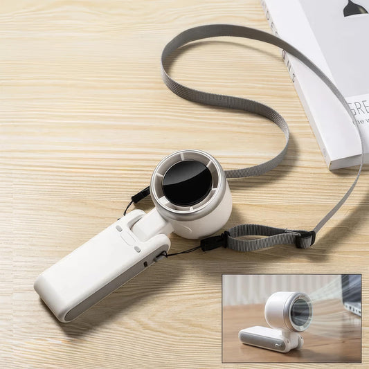 White handheld device with a cylindrical component on a wooden surface, featuring a strap.