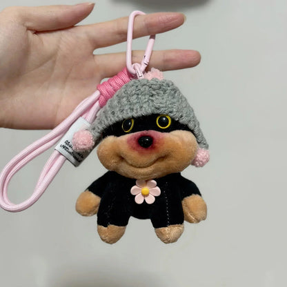 Puppy plush keychain with gray knit hat, pink lanyard, and flower pendant