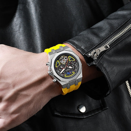 Close-up of a wrist wearing a watch with a yellow strap and black face, against a dark leather jacket background.