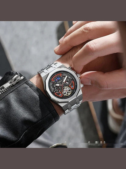 Men's automatic sports watch on wrist with silver case, black dial, metal bracelet, detailed dial