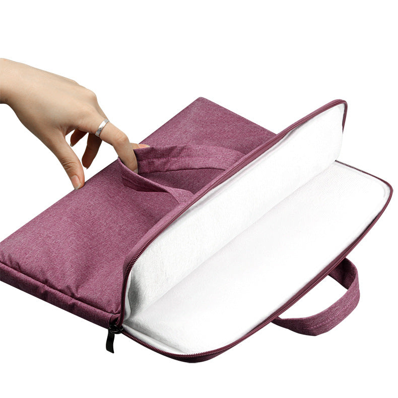 Purple laptop bag with a hand opening it on a white background