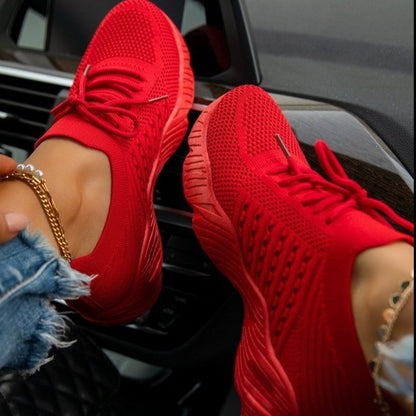 Red women’s lightweight fashion sneakers with breathable knit upper and shock-absorbing sole