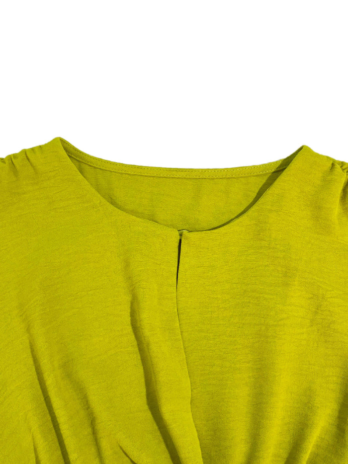 Close-up of a green dress with a plain background