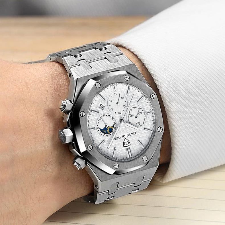 Silver watch with detailed face on a wrist, brand visible