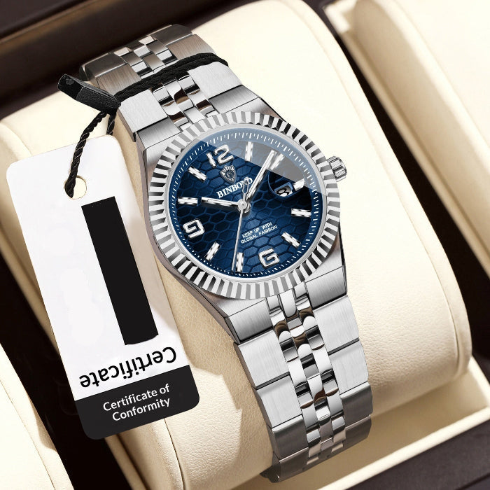 Silver women's watch with blue dial on a white cushion, accompanied by a tag.