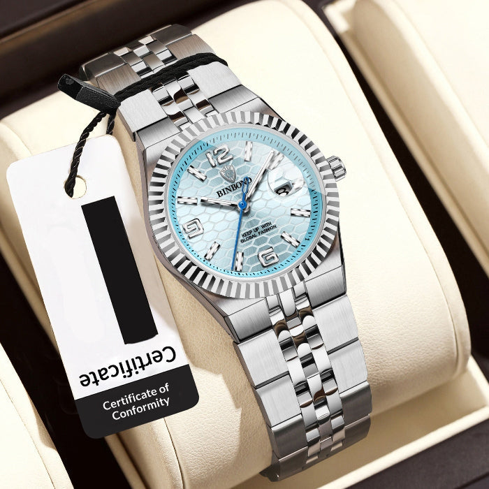 Silver women's wristwatch with a blue face on a beige cushion, accompanied by a price tag.