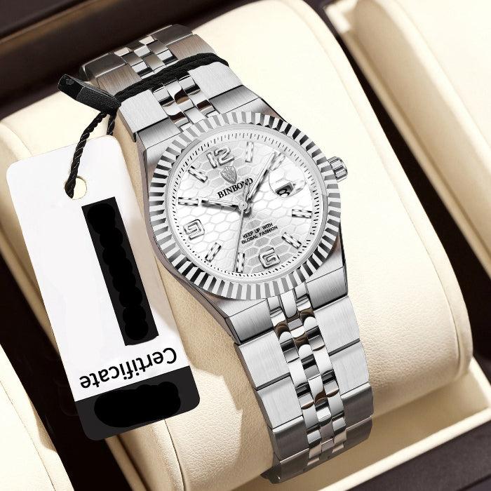 Silver wristwatch with a certificate tag on a beige cushion