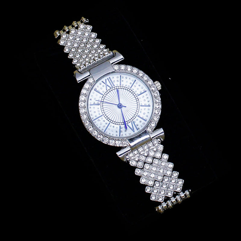 Silver wristwatch with gemstone-encrusted band on a black background