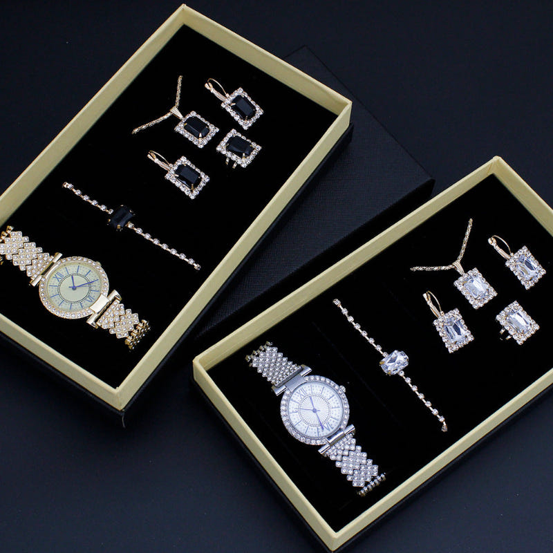 Silver-tone watch, rhinestone earrings, and bracelet set in two gift boxes