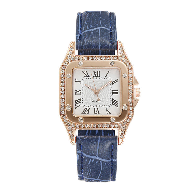 Watch with blue strap and rose gold case on a white background
