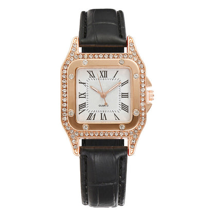 Wristwatch with black strap and rose gold case on a white background