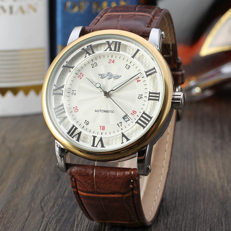 Wristwatch with brown leather strap and gold case on a wooden surface