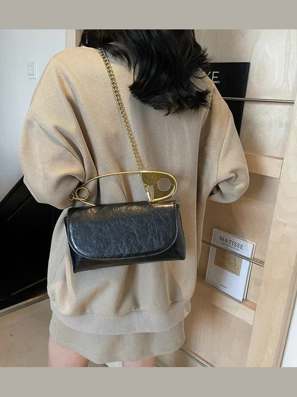 Black PU leather shoulder bag with gold ring handle and chain strap, flap closure
