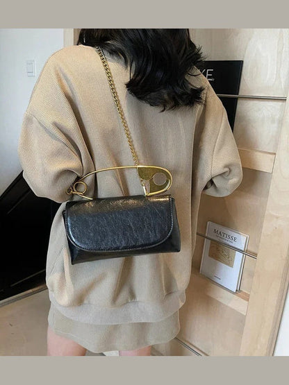 Black PU leather shoulder bag with gold ring handle and chain strap, flap closure