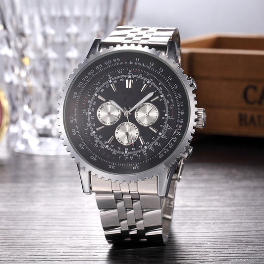 Silver wristwatch with a detailed face on a wooden surface