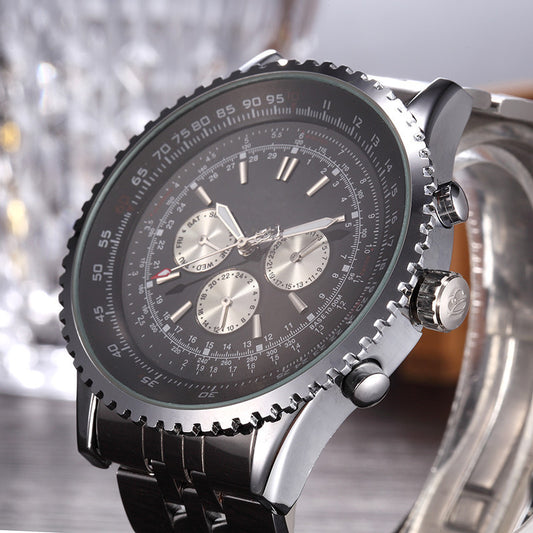 Close-up of a silver and black watch with detailed face