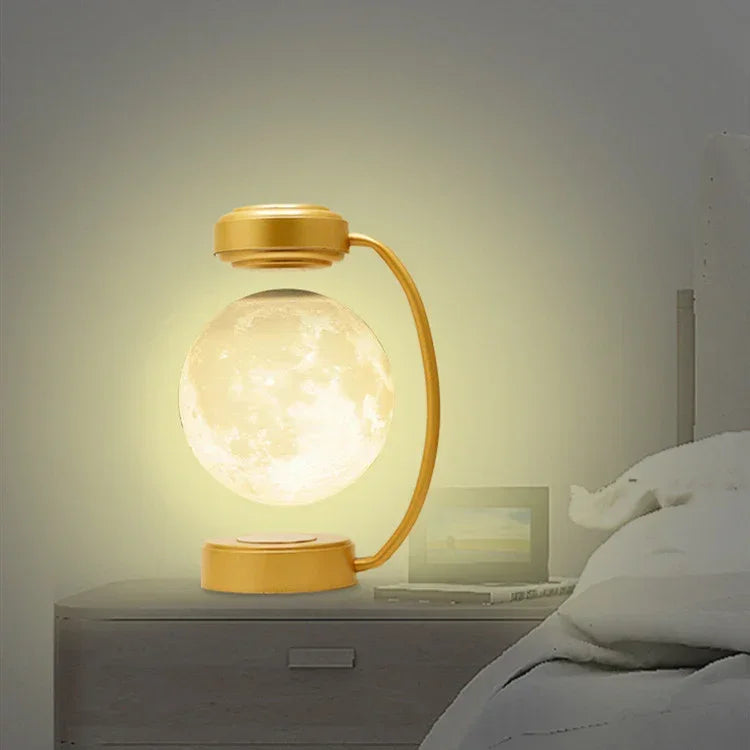 Gold moon LED night light with frosted globe and curved arm, glowing softly.