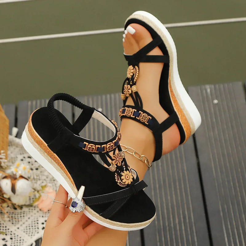 Black platform sandals with ankle strap, gold floral embellishments, thick sole edge